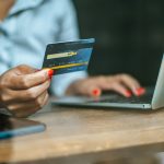 woman sat with a laptop and paid with a credit card