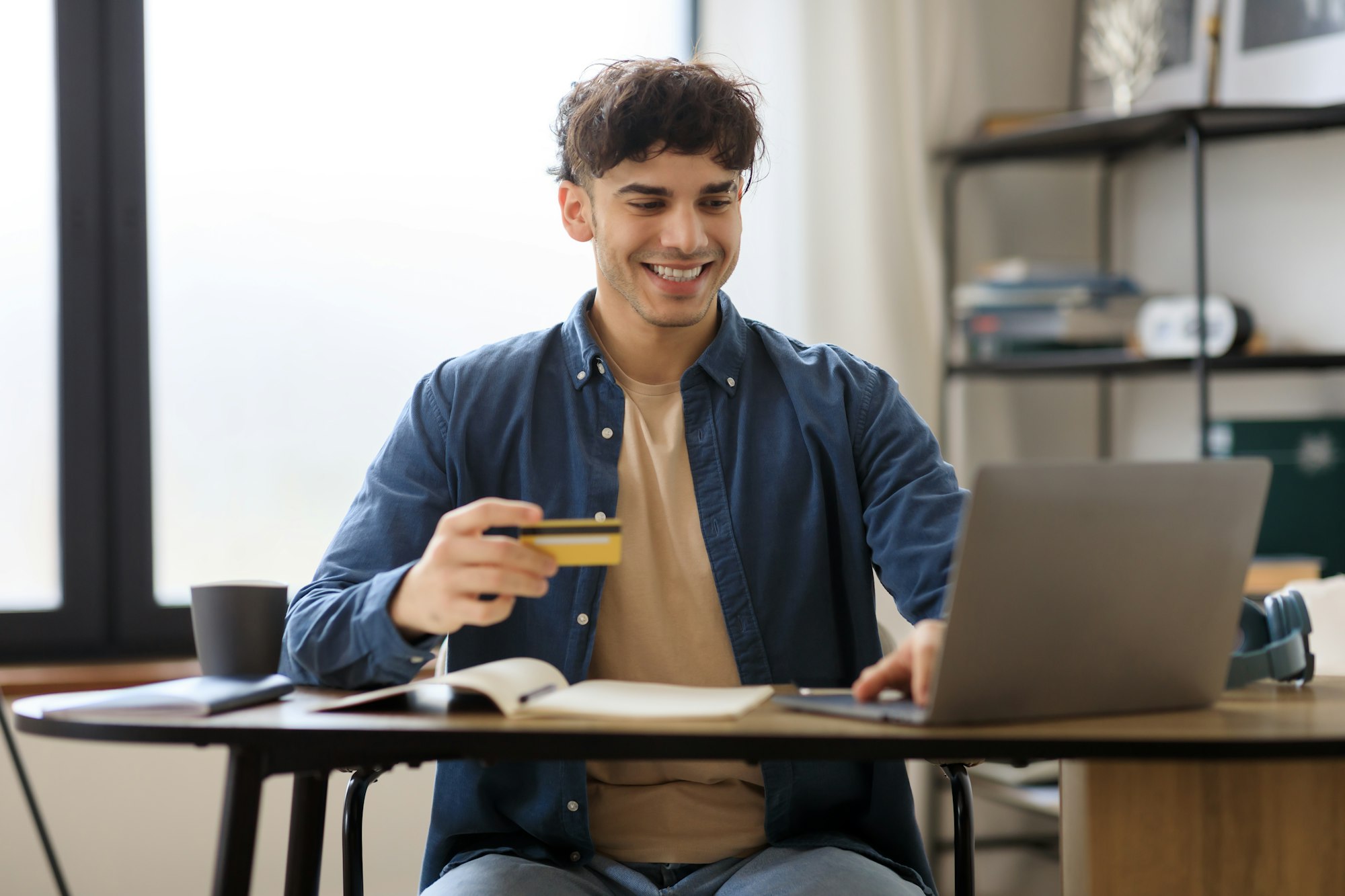 Arabic Man Shopping Using Laptop And Credit Card In Office