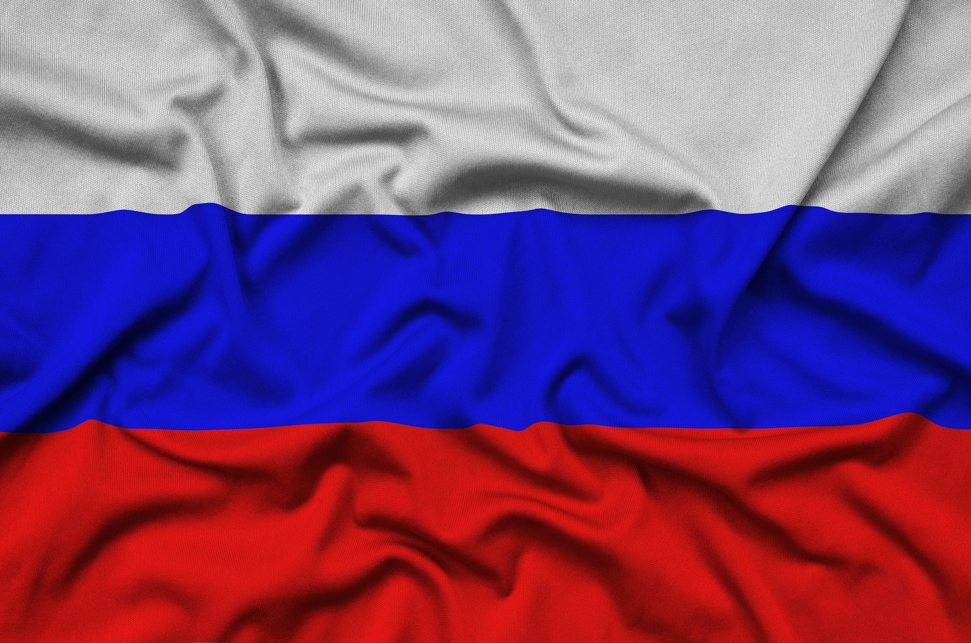 Russia flag is depicted on a sports cloth fabric with many folds. Sport team waving banner