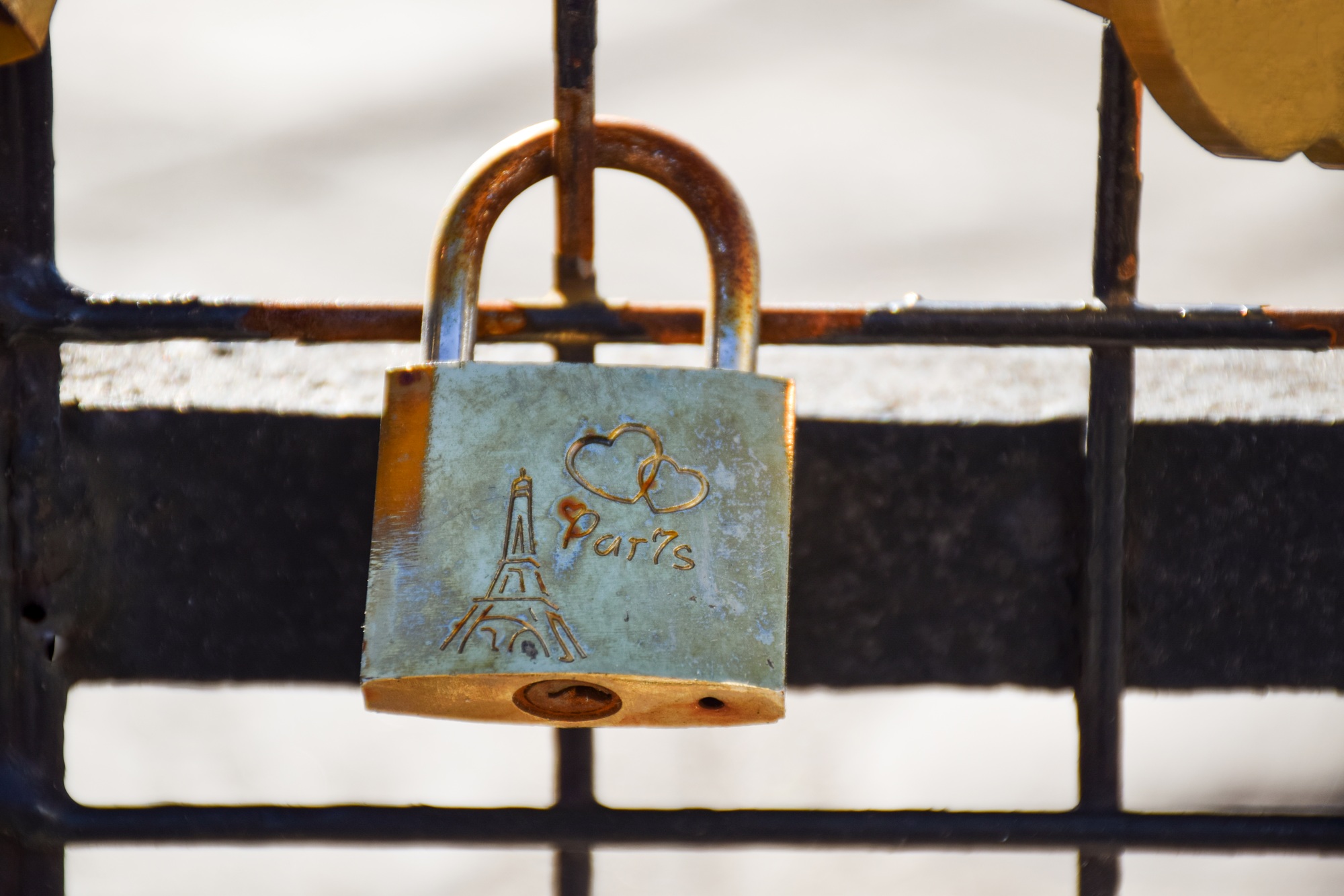 Wedding key lock with a heart and Paris on the bridge close-up on a sunny summer day. Paris, France