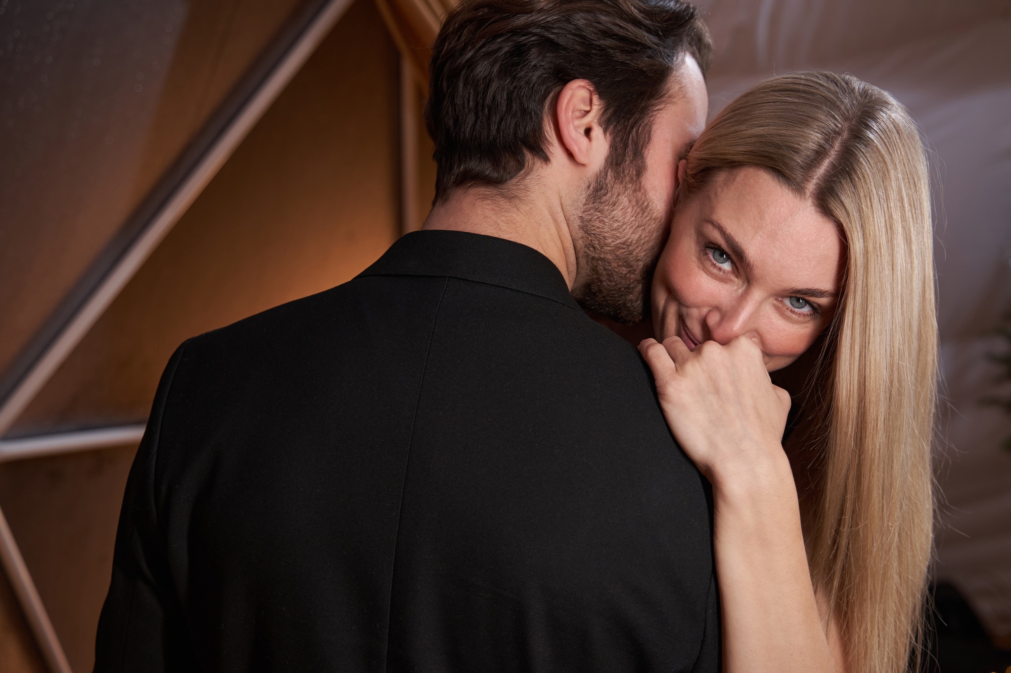 Woman shyly smiling to camera during dance with man